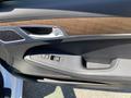 Interior door panel of a 2017 Genesis G80 featuring window controls and a wood trim accent
