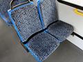 Two blue and patterned seats in a vehicle interior with a clean design