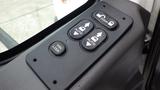 Control panel featuring buttons for door operation and window controls in a 2012 International 7400