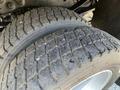 Close-up of a worn tire on a 2013 Ford F-450 SD showing visible tread patterns and signs of use