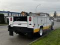 A 2019 Ford F-550 service truck with a yellow and white exterior featuring a utility bed and rear-mounted equipment