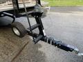 A close-up of a black trailer hitch attached to a boat with a wheel and a winch system for securing and loading the boat