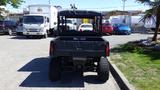 A black 2016 Polaris Ranger 570 Crew off-road vehicle with a utility bed and large tires parked in an outdoor setting