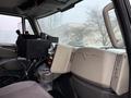 Interior view of a 2016 International 7400 truck showing the dashboard controls and seating area with a console and integrated display