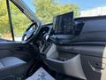 Interior view of a 2022 Ford Transit featuring a steering wheel and a large touchscreen display on the dashboard