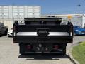 A rear view of a black 2019 Ford F-550 with a dump truck bed and red taillights