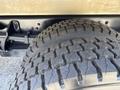 A close-up of a rugged tire on a 2020 Chevrolet Silverado showing deep tread patterns designed for off-road performance