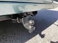 Close-up of a tow hitch attached to a 2000 Ford Motorhome showcasing a round ball mount designed for towing trailers