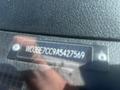 Close-up of a metal plate displaying the VIN WD3BE7CC9A5427569 on the dashboard of a 2010 Mercedes-Benz Sprinter van