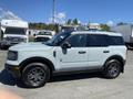 A light blue 2023 Ford Bronco Sport parked with a sleek design and black wheels showcasing its rugged appearance
