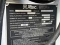 A label from an Altec Industries model AT200AV attached to a 2007 Ford Econoline indicating capacity specs and operating instructions
