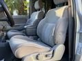A 2004 Toyota Tacoma featuring two front seats with a gray fabric upholstery and a center console between them