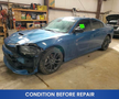 A blue 2022 Dodge Charger with visible damage and missing parts, showcasing a sporty design and black alloy wheels