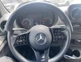 A 2022 Mercedes-Benz Sprinter steering wheel with control buttons and a central display showing vehicle information
