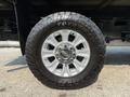 A close-up of a 2020 Ford F-350 SD wheel featuring a silver alloy rim and a rugged Toyo Open Country tire