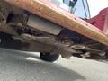 Underside view of a 2012 Toro Groundsmaster 5910 showing rusted metal components and mower blades