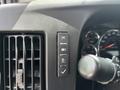 A control panel featuring three buttons and a lever on the dashboard of a 2020 Chevrolet Express van