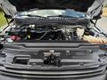 A 2017 Ford F-550 with the hood open revealing the engine compartment showcasing various engine components and fluid reservoirs