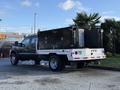 A 2008 Ford F-550 with a black flatbed design featuring two large black toolboxes mounted at the back