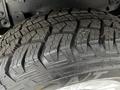 Close-up of a tread pattern on a 2020 Ford F-350 SD tire showing deep grooves and a rugged design for off-road traction
