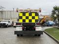 A 2016 Freightliner 108SD truck with a large yellow and black checkerboard pattern on its rear section