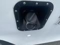 Close-up view of the fuel filler cap on a 2004 Ford Econoline van showing the circular cap and surrounding black plastic housing