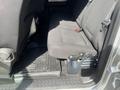 The interior of a 2014 Ford F-150 showing the rear seat with gray fabric upholstery and a rubber floor mat