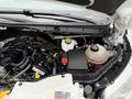 The image shows the engine compartment of a 2017 Ford Transit T150 XLT highlighting various components including the battery coolant reservoir and engine parts