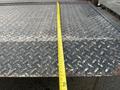 A 2008 Mitsubishi Fuso FE180 flatbed truck with a diamond plate surface and a measuring tape laid across the top