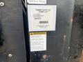 A 2008 Mitsubishi Fuso FE180 with a Tommy Gate lift attached displaying warning and part information stickers