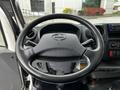 The interior view of a 2014 Hino 195 showing the steering wheel and dashboard controls