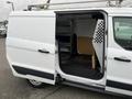 A white 2017 Ford Transit Connect with an open side door showing the cargo area equipped for utility use