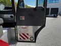 A 2006 Emergency One Fire Truck door with a metal handle and safety warning stickers visible on the side