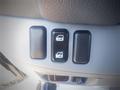 Three buttons located on a vehicle's interior panel for controlling the windows or doors