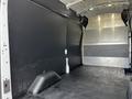 Interior view of a 2020 Ford Transit cargo van showing a spacious empty cargo area with black flooring and metal paneling on the walls