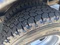 Close-up of a worn tire with an intricate tread pattern mounted on a wheel visible on a 2020 Chevrolet Express
