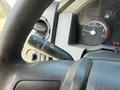 Close-up view of the steering wheel of a 2012 Ford F-450 SD showing controls for lights and wipers along with the gauge cluster