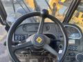 View of the steering wheel and control panel of a 2013 JCB 510-56 Loadall featuring various levers switches and gauges