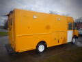 A yellow 2008 Freightliner MT45 Chassis with a boxy cargo area and white wheels positioned in a side view