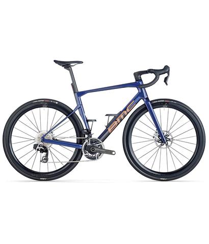 2025 BMC Roadmachine 01 ONE Road Bike with a sleek blue frame drop handlebars and black wheels featuring a lightweight design and advanced components