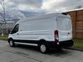 A white 2020 Ford Transit van viewed from the rear showing a high roof and sliding side door with black accents on the lower body and wheels