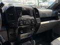 Interior dashboard of a 2016 Ford F-150 featuring controls for audio, climate settings, and a digital display