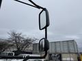 A 2016 International CE300 truck with two side mirrors reflecting the sky and surroundings