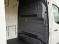 Interior view of a 2019 Mercedes-Benz Sprinter showing the rear cargo area with a gray panel and features for cargo storage