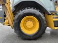 A 2011 John Deere 310SJ 4x4 Wheel Loader Extended Hoe with a large yellow and black tire showing visible tread pattern