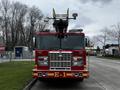 A red 2009 Spartan Gladiator fire truck with the number E-1 prominently displayed on the front and various emergency lights on the top