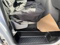 Interior of a 2008 Ford Econoline showing a driver's seat covered with a black seat cover and a piece of brown paper on the floor mat