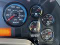 The dashboard of a 2013 International DuraStar 4300 displaying various gauges for speed, fuel, voltage, and brake air pressure