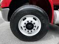 Close-up of a Goodyear tire mounted on a white rim of a 2011 International 4400 truck showing the wheel bolts and tread pattern