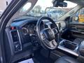 Interior view of a 2017 RAM 1500 showing the steering wheel dashboard and center console with controls and display features